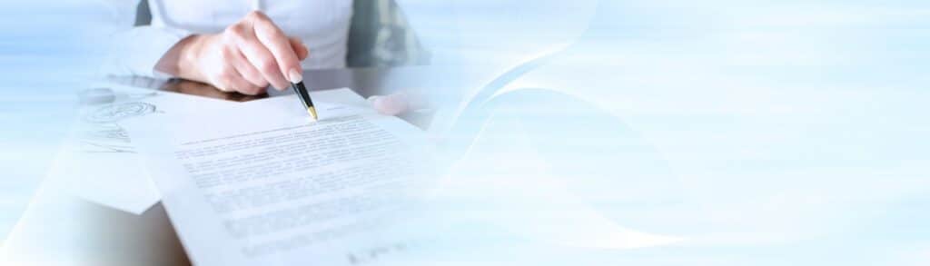 Small business owner preparing loan documents to qualify for a business loan