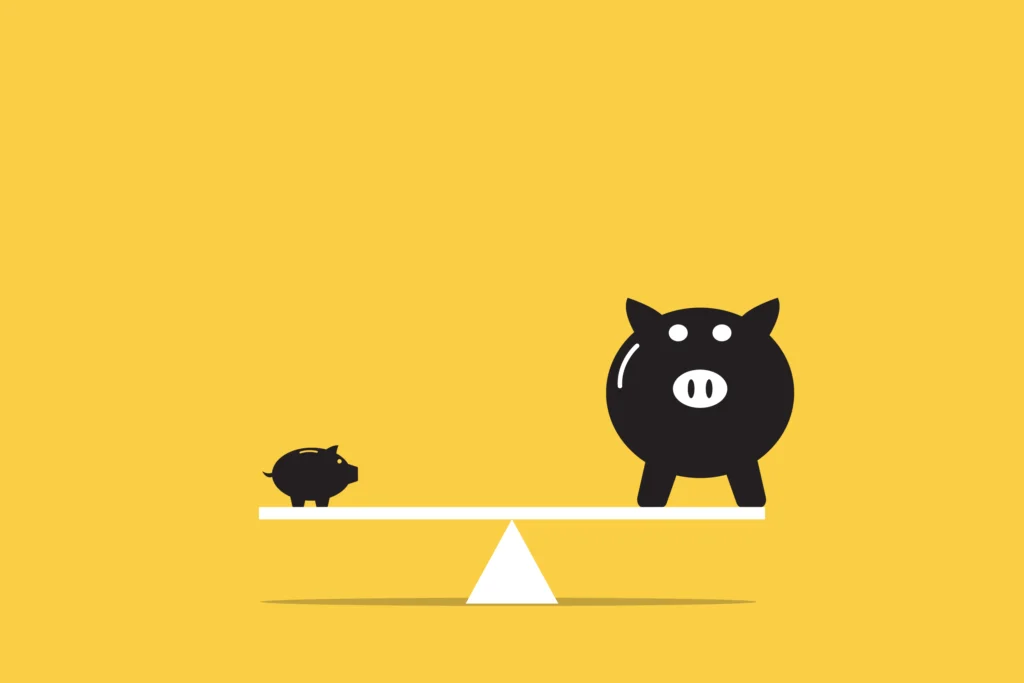 Illustration of two piggy banks of different sizes balancing on a seesaw, symbolizing comparing business loan options or funding sizes.